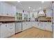 Well-lit kitchen with ample storage, stainless steel appliances, and beautiful countertops, ideal for cooking and entertaining at 1299 Harding Street, Winter Park, FL 32789