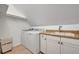 Functional laundry room featuring washer, dryer, sink, and cabinet space at 1299 Harding Street, Winter Park, FL 32789