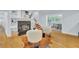 Cozy living room featuring a fireplace, hardwood floors, and a staircase, offering a warm and inviting ambiance at 1299 Harding Street, Winter Park, FL 32789