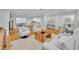 Bright, open living room featuring hardwood floors, stylish seating, and seamless flow to the kitchen and other spaces at 1299 Harding Street, Winter Park, FL 32789