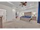 Spacious main bedroom with tray ceilings, ceiling fan, and carpet floors at 1299 Harding Street, Winter Park, FL 32789