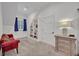 Bright sitting room with a red velvet couch, bookshelves, and a side table at 1299 Harding Street, Winter Park, FL 32789