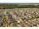 Neighborhood aerial view showcasing homes, street layout, and nearby recreational area and bodies of water at 542 Patton Loop, Bartow, FL 33830