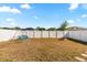 Spacious fenced backyard featuring a fire pit and a swing set, perfect for outdoor activities at 542 Patton Loop, Bartow, FL 33830