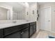 Spacious bathroom with double sinks, a large mirror, dark cabinets, and tiled floors at 542 Patton Loop, Bartow, FL 33830