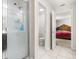 Bathroom with glass shower stall, toilet, and view into the Primary bedroom at 542 Patton Loop, Bartow, FL 33830
