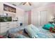 Bright bedroom featuring a comfortable bed, ceiling fan, closet, and a wall-mounted TV above a white dresser at 542 Patton Loop, Bartow, FL 33830