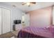 Comfortable bedroom with a TV, closet, ceiling fan, and soft carpet flooring at 542 Patton Loop, Bartow, FL 33830