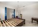 Bedroom view featuring furniture, tiled flooring, and an elegant chandelier at 542 Patton Loop, Bartow, FL 33830