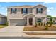 Charming two-story home features a welcoming entrance and a two-car garage at 542 Patton Loop, Bartow, FL 33830