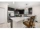 Beautiful kitchen with an island, stainless appliances and eat-in bar with upholstered stools at 542 Patton Loop, Bartow, FL 33830