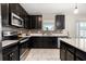 Well-equipped kitchen with stainless steel appliances, sleek cabinetry, and tile backsplash at 542 Patton Loop, Bartow, FL 33830