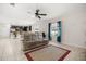 Open-concept living room with tile flooring, ceiling fan, and comfortable seating area at 542 Patton Loop, Bartow, FL 33830
