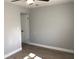 A bedroom with light-colored walls, wood-look floors, and white trim at 5508 Andora St, Orlando, FL 32807