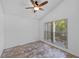 Bright bedroom with tile floors, a ceiling fan, and a large window offering plenty of natural light for a cozy and inviting atmosphere at 9301 Echo Run, Orlando, FL 32817
