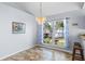 Cozy dining area with elegant chandelier, large window with backyard views, and tile flooring, perfect for intimate gatherings at 9301 Echo Run, Orlando, FL 32817