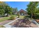 Charming home featuring a well-manicured lawn, a brick patio, and mature trees at 9301 Echo Run, Orlando, FL 32817