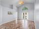 Bright living room showcasing tile floors, vaulted ceilings, and French doors leading to the backyard, inviting relaxation and entertainment at 9301 Echo Run, Orlando, FL 32817