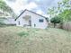 Spacious backyard features a patio, lush greenery, and is surrounded by a wooden fence for added privacy at 1002 Courtland St, Orlando, FL 32804
