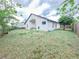 Large backyard featuring a covered patio and lush lawn, perfect for outdoor gatherings and relaxation at 1002 Courtland St, Orlando, FL 32804