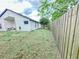View of backyard with privacy fence and green trees, providing a serene and secluded outdoor space at 1002 Courtland St, Orlando, FL 32804