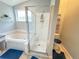 Bright bathroom features a glass enclosed shower and separate soaking tub, and a sunny window at 1002 Courtland St, Orlando, FL 32804
