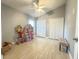 Bedroom with light tile flooring and a neutral paint scheme; features closet space and a ceiling fan at 1002 Courtland St, Orlando, FL 32804