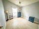 Neutral bedroom with wood look tile floors and one window providing natural light at 1002 Courtland St, Orlando, FL 32804