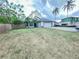 Charming single-story home featuring a well-maintained front lawn, mature trees, and a two-car garage at 1002 Courtland St, Orlando, FL 32804