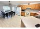 Cozy kitchen with tile flooring, wooden cabinets, and matching dining area with natural light at 1002 Courtland St, Orlando, FL 32804