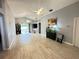Bright and spacious living room featuring tile flooring, ceiling fans, and sliding glass door to the yard at 1002 Courtland St, Orlando, FL 32804