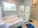 Clean main bathroom featuring a shower and bathtub combination, tile flooring, and natural light at 1002 Courtland St, Orlando, FL 32804