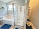 Clean main bathroom featuring a shower and bathtub combination, tile flooring, and natural light at 1002 Courtland St, Orlando, FL 32804