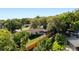 An aerial view showing a house surrounded by mature trees and a fenced backyard at 110 Tedworth Ct, Longwood, FL 32779