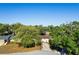 Aerial view of a charming home nestled amongst mature trees with lush landscaping at 110 Tedworth Ct, Longwood, FL 32779