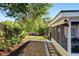 Landscaped backyard featuring rock bed, stone pavers, privacy fence and mature trees offer shade at 110 Tedworth Ct, Longwood, FL 32779