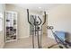 Light-filled exercise room featuring workout equipment and a storage system for shoes at 110 Tedworth Ct, Longwood, FL 32779