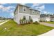 A two-story home with attached garage has a well maintained front yard with manicured landscaping at 16448 Winding Preserve Cir, Clermont, FL 34714