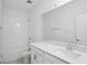 Bathroom boasts tile floors, quartz counters, single vanity, and shower-tub combo at 16484 Silver Brook Way, Winter Garden, FL 34787