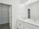 Bathroom features a double sink vanity, quartz counters, and framed mirrors at 16484 Silver Brook Way, Winter Garden, FL 34787
