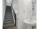 Hallway featuring a powder room with a sink, toilet, and a view of the staircase at 16484 Silver Brook Way, Winter Garden, FL 34787
