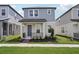Charming two-story home featuring a covered porch and manicured landscaping at 16484 Silver Brook Way, Winter Garden, FL 34787