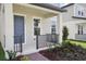 Close-up of a charming front porch with a railing and detailed landscaping at 16484 Silver Brook Way, Winter Garden, FL 34787