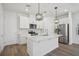 Bright kitchen featuring an island with white countertops, stainless steel appliances, and ample cabinet space at 16484 Silver Brook Way, Winter Garden, FL 34787