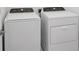 The laundry room contains a new white washer and dryer at 16484 Silver Brook Way, Winter Garden, FL 34787