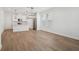 Open-concept living area with a view of the kitchen and hardwood flooring at 16484 Silver Brook Way, Winter Garden, FL 34787