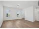 Bright living room with hardwood floors and natural light from large windows at 16484 Silver Brook Way, Winter Garden, FL 34787