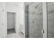 Newly built glass shower boasts modern tile and a view of the bathroom's double vanity at 16484 Silver Brook Way, Winter Garden, FL 34787