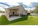 Covered patio with comfortable seating, ceiling fan, and views of the expansive backyard at 16843 Cedar Run Dr, Orlando, FL 32828