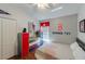 Bright bedroom with sports themed decor, closet, colorful dresser, and large window offering natural light at 16843 Cedar Run Dr, Orlando, FL 32828
